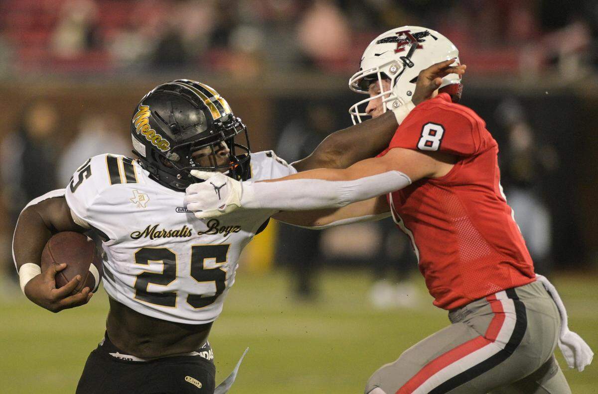 South Oak Cliff running back Damond Williams (25) fends off Argyle defensive back Nathaniel Bruce (8) during a Class 5A Division II state semifinal on Friday, Dec. 13, 2024 at Gerald J. Ford Stadium in University Park, Texas.