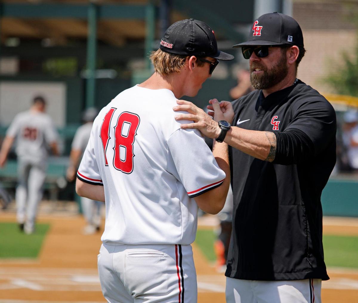 Colleyville assistant coach Brandon Bounds talks with first baseman Jaxon Patton (18) at the conclusion of the inning during the UIL baseball regional final 5A D1 playoff game at Hawk Baseball Field in North Richland Hills, Texas, Thursday, May 22, 2025.