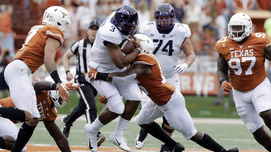 TCU quarterback Shawn Robinson (3) is hit by Texas defensive back Chris Brown (15) on a keeper run during the first half of an NCAA college football game, Saturday, Sept. 22, 2018, in Austin, Texas.