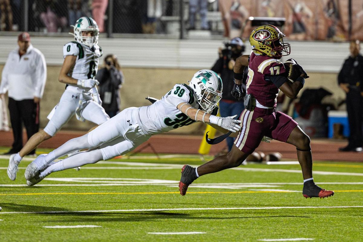 Azle linebacker Cash Hunter (39) attempts to tackle Saginaw wide receiver Boaz Kaloso (17) on his touchdown reception in the first half of an Class 5A Division I playoffs game between Saginaw and Azle at Rough Rider Stadium in Saginaw on Friday, Nov. 15, 2024.