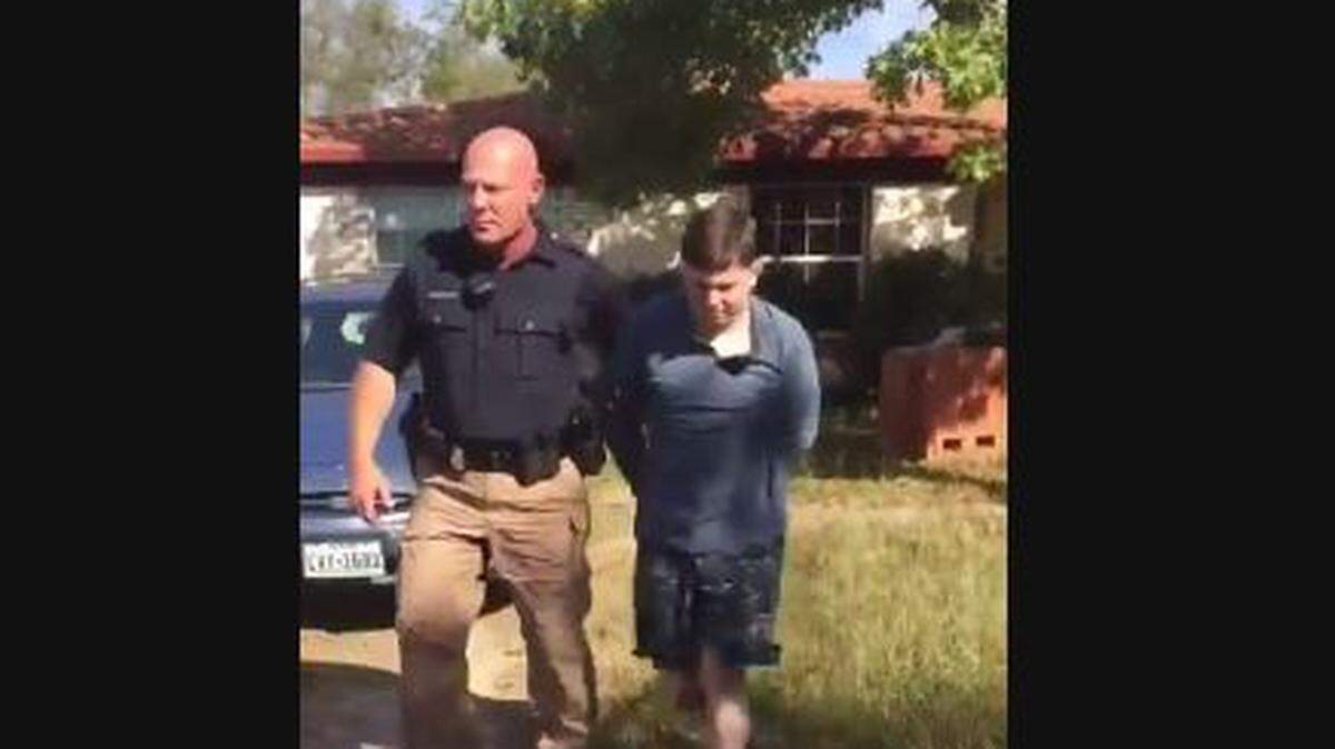 A screenshot from the video of animal cruelty suspect Harrison Hilliard, right, getting arrested Friday.