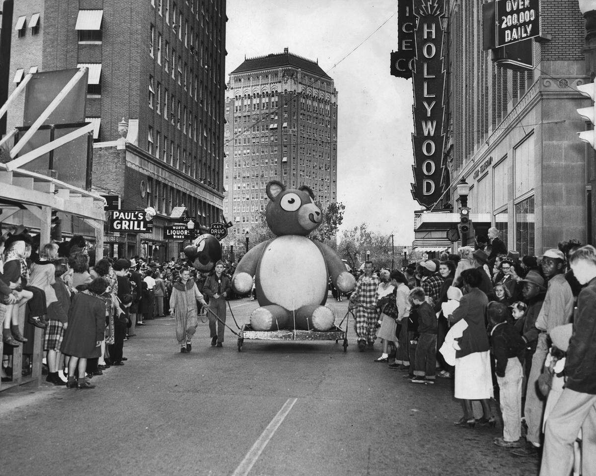Nov. 23, 1951: A teddy bear parade float, being pulled by Boy Scouts, among a crowd of people at the Christmas Parade on Seventh Street in Fort Worth. The parade was held in downtown Fort Worth on the Friday after Thanksgiving.