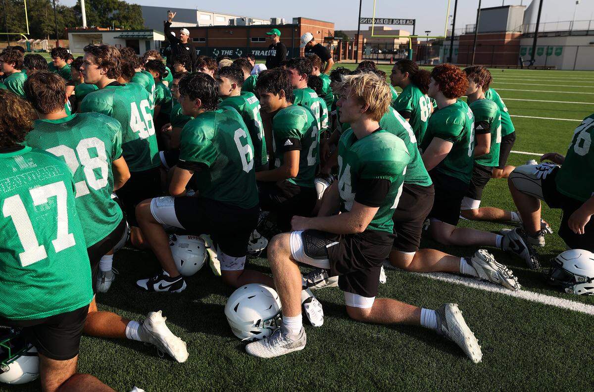 The Southlake Carroll Dragons huddle up at the end of morning practice on Wednesday, Aug. 6, 2025, in Southlake.