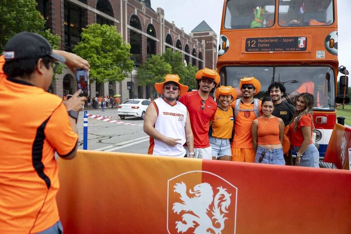 A group of friends from Fort Worth have their photo made in front of the famous Orange Bus on Sunday, June 14, 2026 in Arlington, Texas. The famous double-decker Orange Bus, or De beroemde Oranjebus, is part of a Netherlands fan tradition bringing a sea of orange to the streets before major soccer matches.
