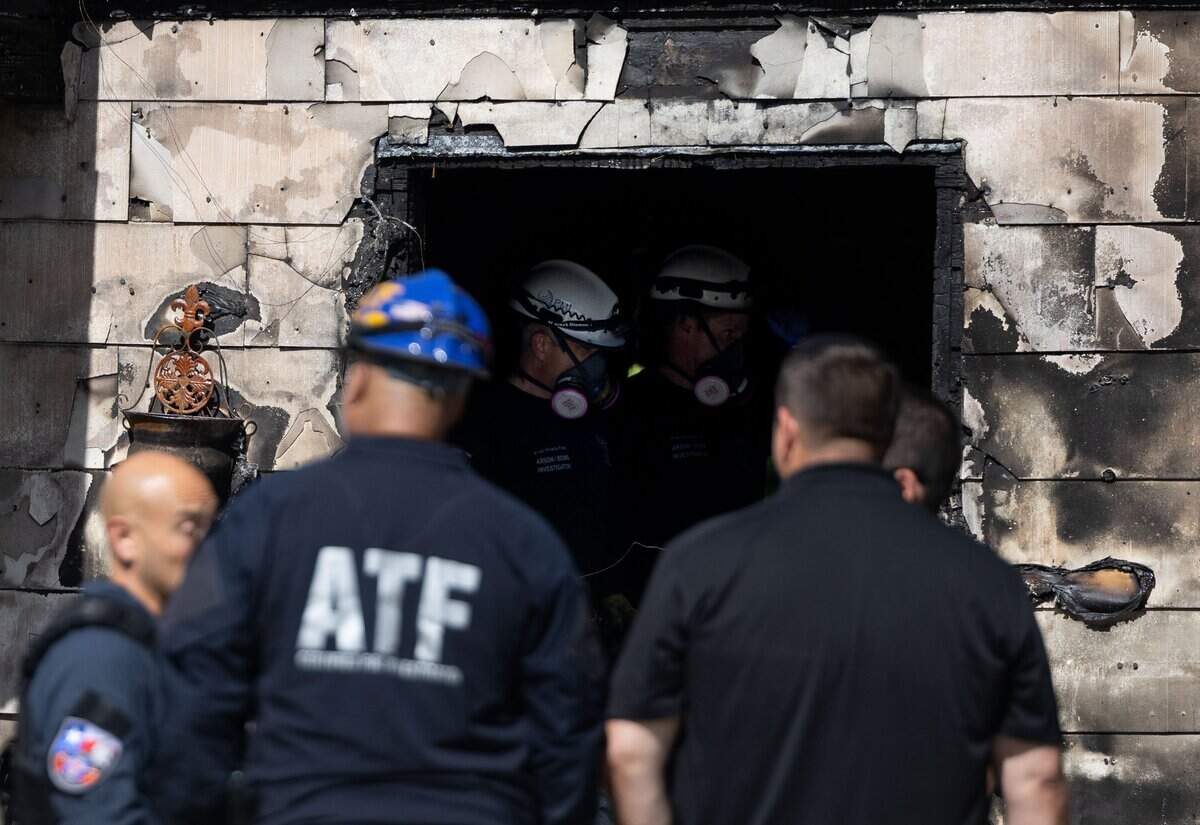 Fire investigators search a house after a fire in south Fort Worth on June 25, 2026.