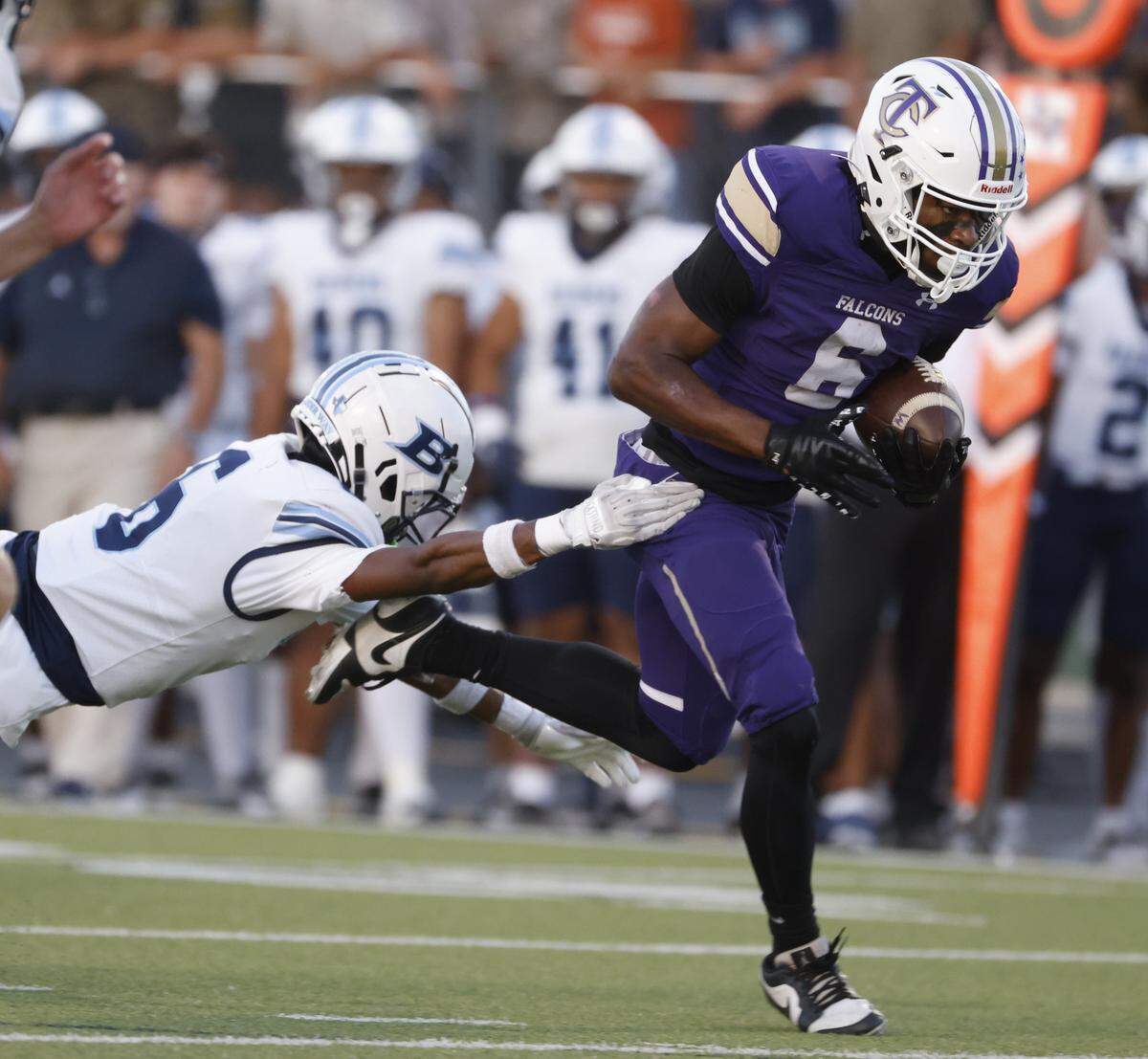 Tiber Creek running back Daren Simmons escapes L.D. Bell defensive back Damarcus Seaton (6) for a touchdown during the first half of a UIL football game between L.D. Bell and Timber Creek at Keller ISD Athletic Complex in Keller on Thursday, Sept. 11, 2025.