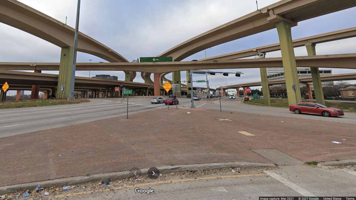 A tow truck driver at the Dallas High Five Interchange died after a woman hit him with her car and he fell over an overpass onto a freeway, police say.
