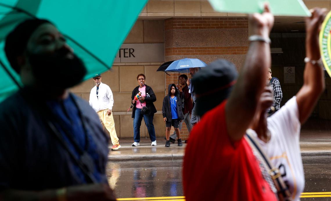 The family of Anthony Johnson, Jr., center, walk to join a protest in front of the Tarrant County Jail on Thursday, May 30, 2024. The Johnson family is demanding the release of the full video showing their son Anthony Johnson Jr.’s death while in custody at the jail.
