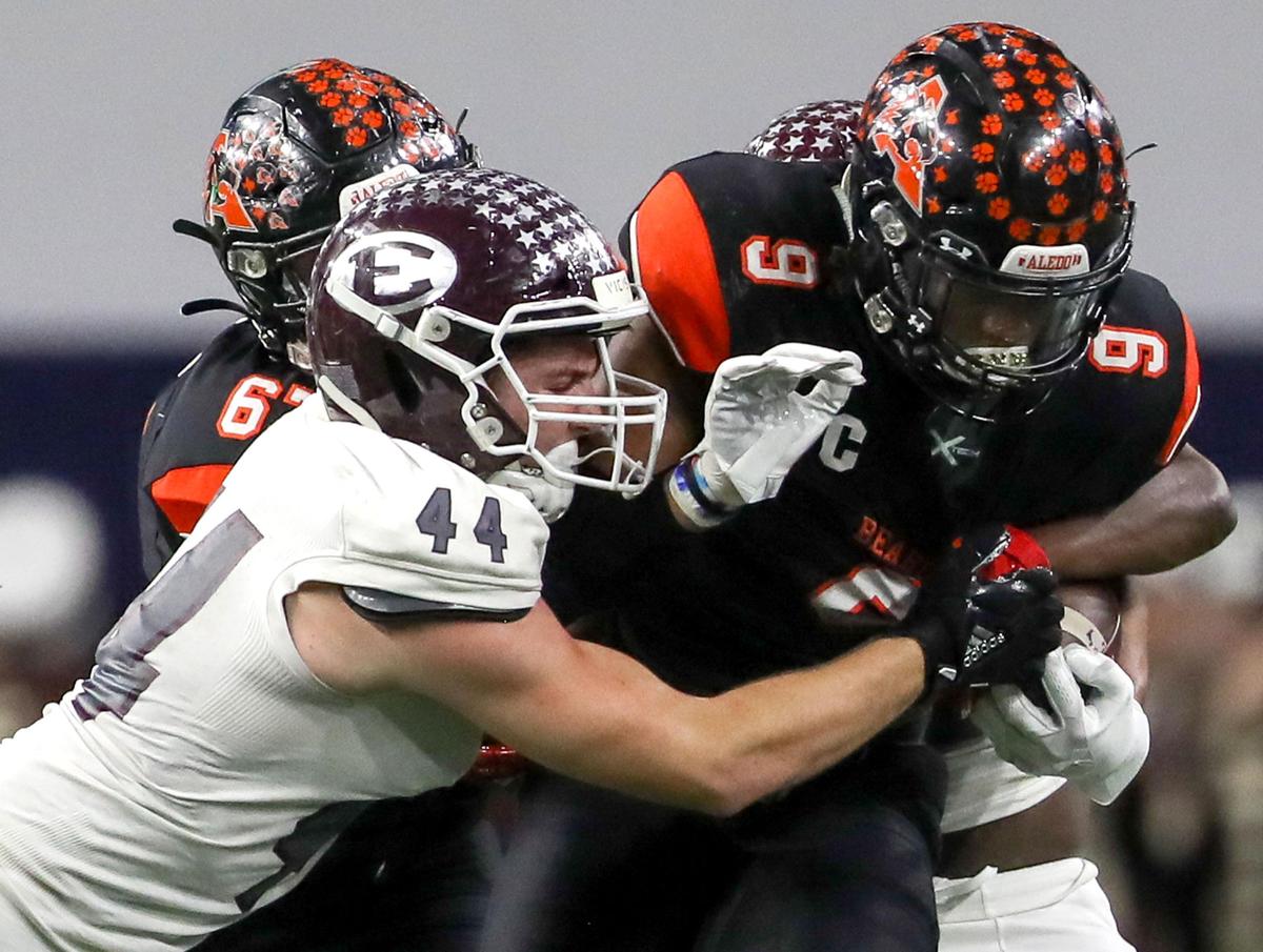 Aledo running back Jase McClellan (9) gets stopped by Ennis linebacker Dane Vernor (44) during the first half of the 5A Division II State quarterfinal high school football playoff game played at the Ford Center in Frisco, TX Friday, December 6, 2019.