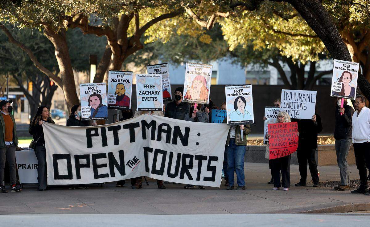 Supporters of the nine defendants indicted in connection to the nonfatal shooting of a police officer outside a North Texas ICE detention center last year chant across the street from the federal courthouse downtown Fort Worth on Monday, Feb. 23, 2026. A second attempt of the trial began Monday after the judge declared a mistrial during jury selection in the previous trial.