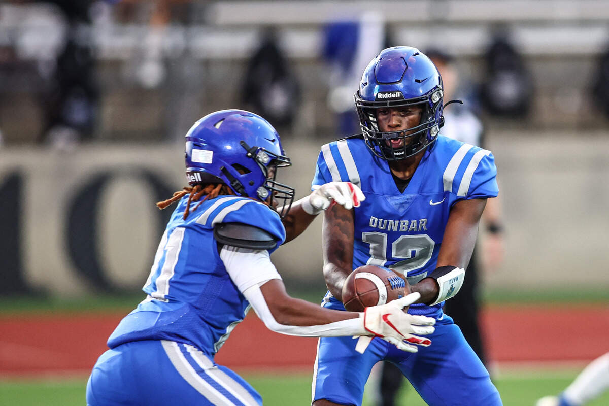Dunbar quarterback Marcus McDade hands the ball off to JaMarion Garrett against Wyatt on Thursday, September 5, 2024 at Clark Stadium in Fort Worth, Texas. Dunbar rallied to defeat Wyatt 14-13.