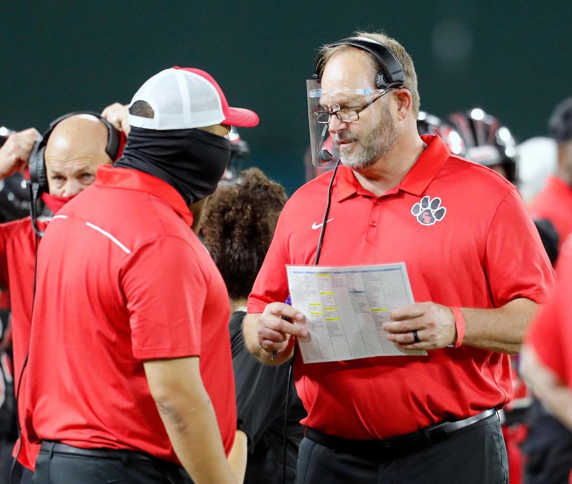 First year, Colleyville Heritage head coach Kirk Martin talks with another coach during a high school football game at Globe Life Park in Arlington, Texas, Saturday, Sept. 26, 2020. Colleyville led 28-24 at the half. (Special to the Star-Telegram Bob Booth)
