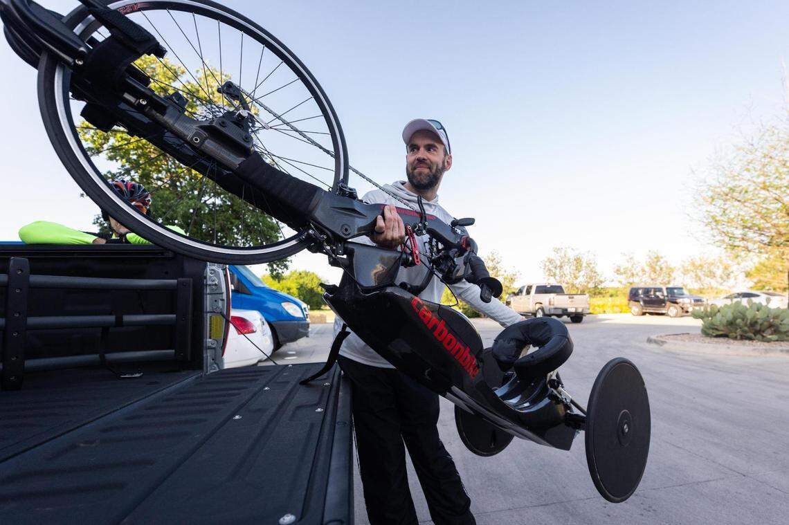 Trent Fielder pulls his bike out of his truck for a 100-mile ride on the Trinity Trails on April 26, 2022, in Fort Worth. Fielder has Guillain-Barre syndrome and uses a specialized bike. Recently, a man attempted to rob Fielder while he was riding on the Trinity, but Fielder decided not to let that deter him from using the trails.
