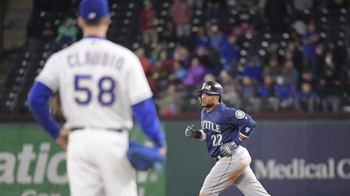 Mariners second baseman Robinson Cano rounds the bases on his two-run home run against Rangers reliever Alex Claudio in the seventh inning Saturday night at Globe Life Park.