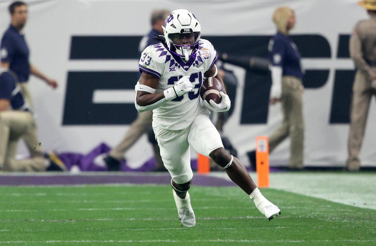 TCU running back Kendre Miller runs the ball against Michigan during the Vrbo Fiesta Bowl at State Farm Stadium in Glendale, Ariz., on Saturday, December 31, 2022.