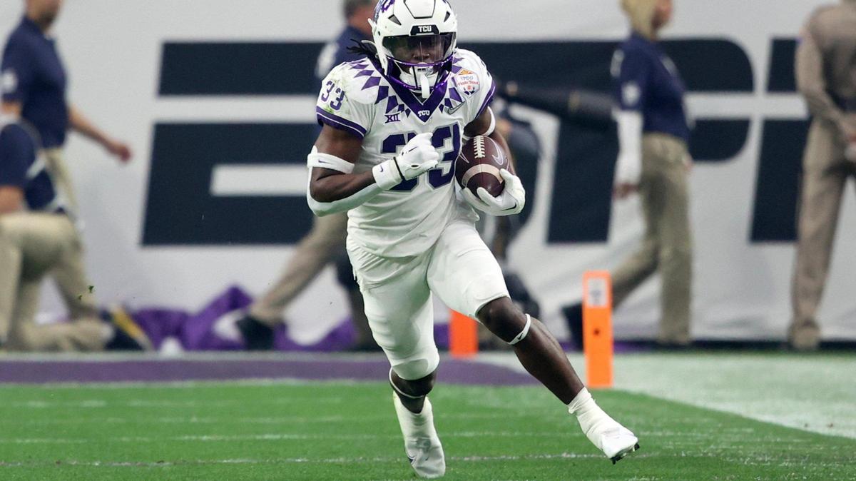 TCU running back Kendre Miller runs the ball against Michigan during the Vrbo Fiesta Bowl at State Farm Stadium in Glendale, Ariz., on Saturday, December 31, 2022.