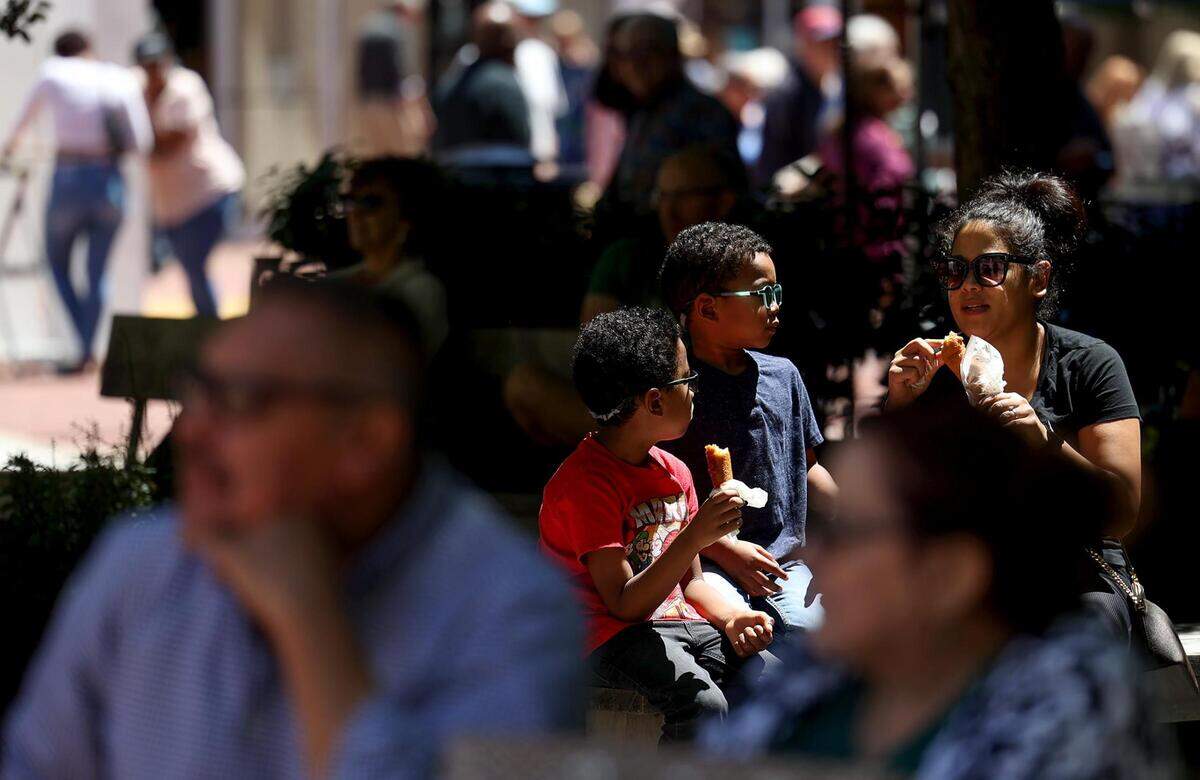 Visitors enjoy food and music at the Fort Worth Art Fair in Sundance Square on Friday, April 21, 2023.