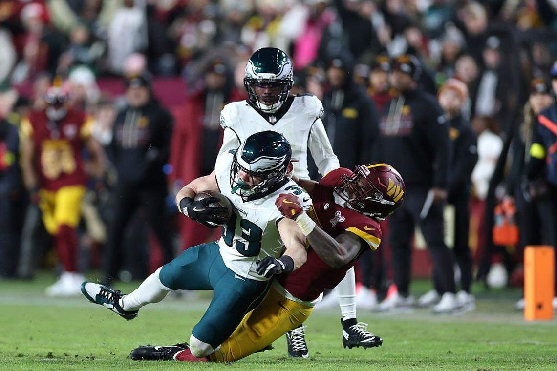 LANDOVER, MARYLAND - DECEMBER 20: Cooper Dejean #33 of the Philadelphia Eagles intercepts a pass against Treylon Burks #13 of the Washington Commanders in the third quarter at Northwest Stadium on December 20, 2025 in Landover, Maryland. (Photo by Scott Taetsch/Getty Images)
