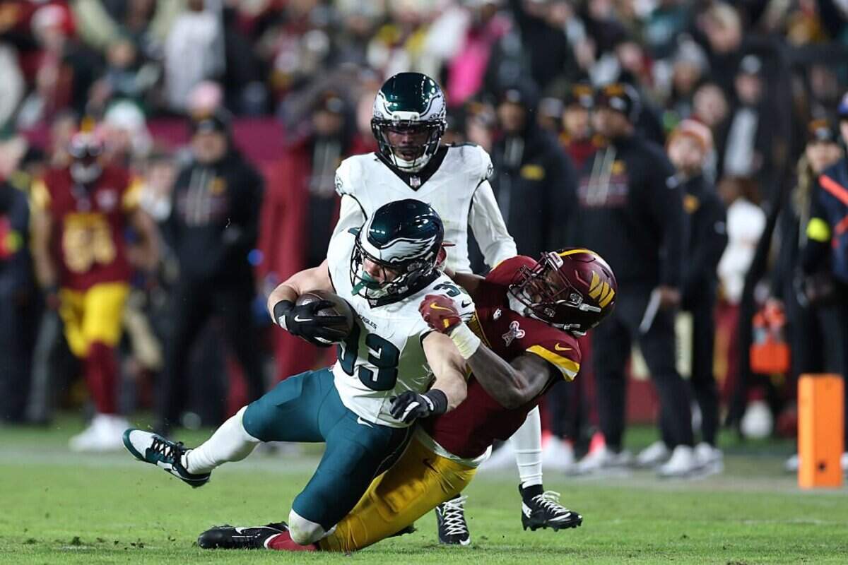 LANDOVER, MARYLAND - DECEMBER 20: Cooper Dejean #33 of the Philadelphia Eagles intercepts a pass against Treylon Burks #13 of the Washington Commanders in the third quarter at Northwest Stadium on December 20, 2025 in Landover, Maryland. (Photo by Scott Taetsch/Getty Images)
