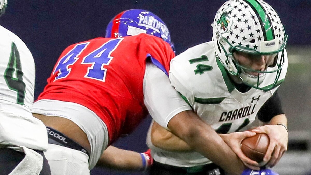 Southlake Carroll quarterback Will Bowers (14) gets sacked by Duncanville defensive lineman Charleston Craddock (44) during the first half, Saturday afternoon, December 8, 2018 in the 6A Division I quarterfinal playoff game played at the Ford Center in Frisco, TX.