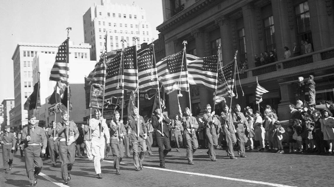 Nov. 11, 1943: Massed flags from Fort Worth Army and American Legion posts lead the parade through downtown streets Thursday morning in the observance of the 25th anniversary of Armistice Day. This Veterans Day, we remember the sacrifices of brave military men and women.