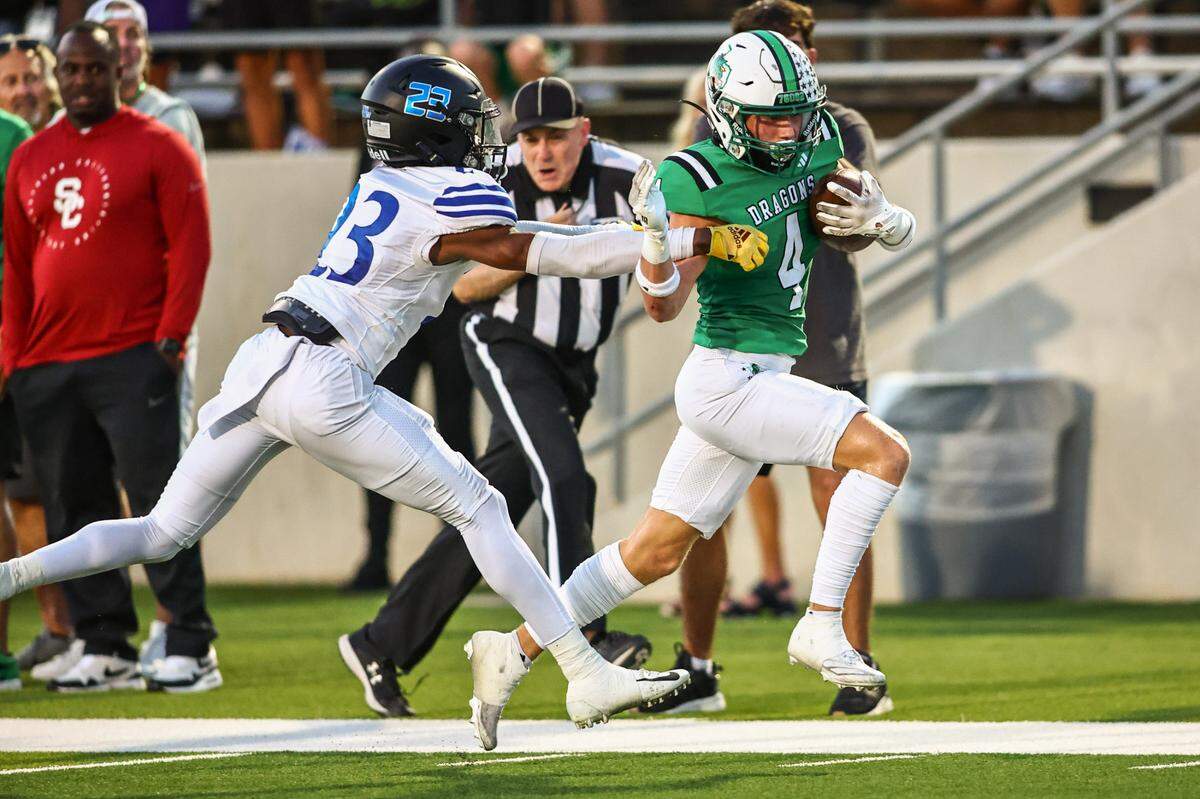 Southlake Carroll receiver Luc Jaquemard (4) scores in front of Trophy Club Byron Nelson’s Jessy Kabeya (23) in a District 4-6A game on Friday, September 13, 2024 at Dragon Stadium in Southlake, Texas.