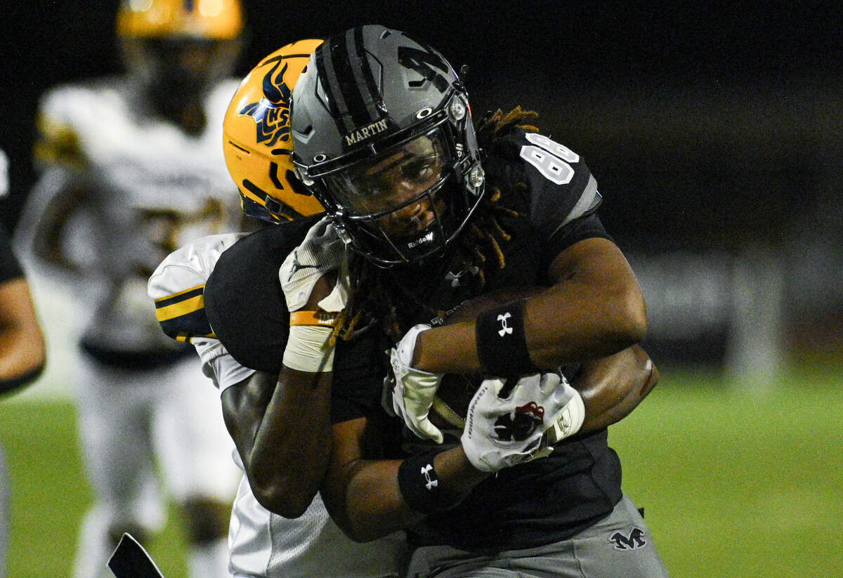 Martin High School tight end Jimmy Steele (88) holds onto the ball while being tackled during a UIL football game against Lamar High School at Cravens Field in Arlington, Texas on Friday, Sept. 20, 2024.
