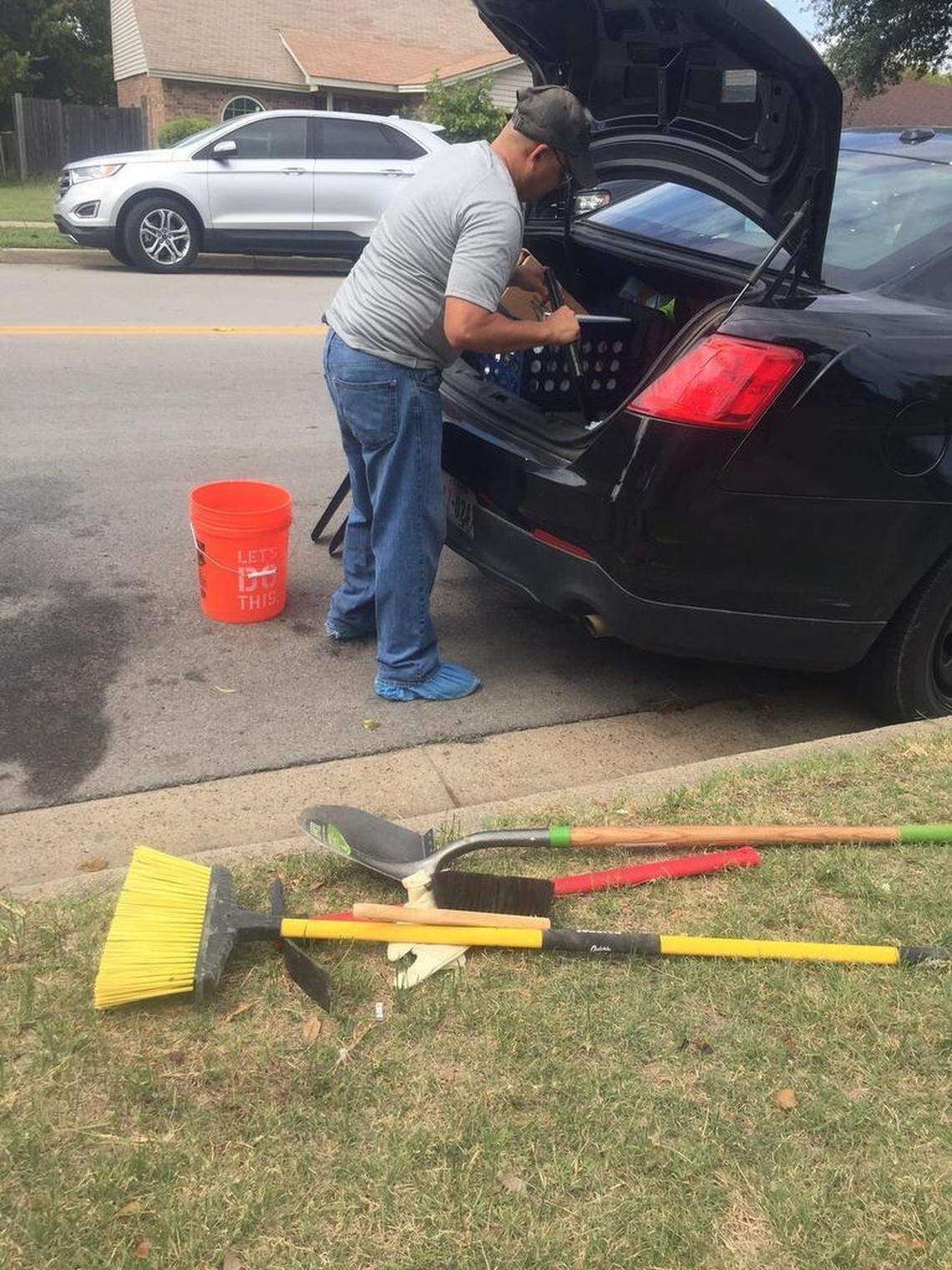 Homicide Detective Scott McCarthy puts away shovels and other tools at a house on Woodway Drive in southwest Fort Worth where a body was found.