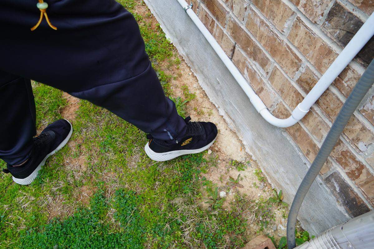 Steve Loftin points out erosion at the base of his home in west Fort Worth, a symptom, he believes, of years of poor drainage issues begot by poor construction.