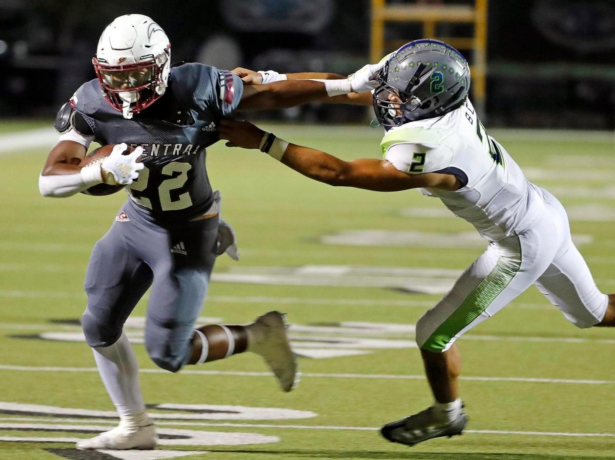 Keller Central running back Chase Garnett (22) stiff arms Eaton defensive lineman Jayson McNabb (2) during a district 4-6A high school football game at Keller ISD Stadium in Keller, Texas, Thursday, Oct. 06, 2022. Eaton led Keller Central 24-10 at the half. (Special to the Star-Telegram Bob Booth)
