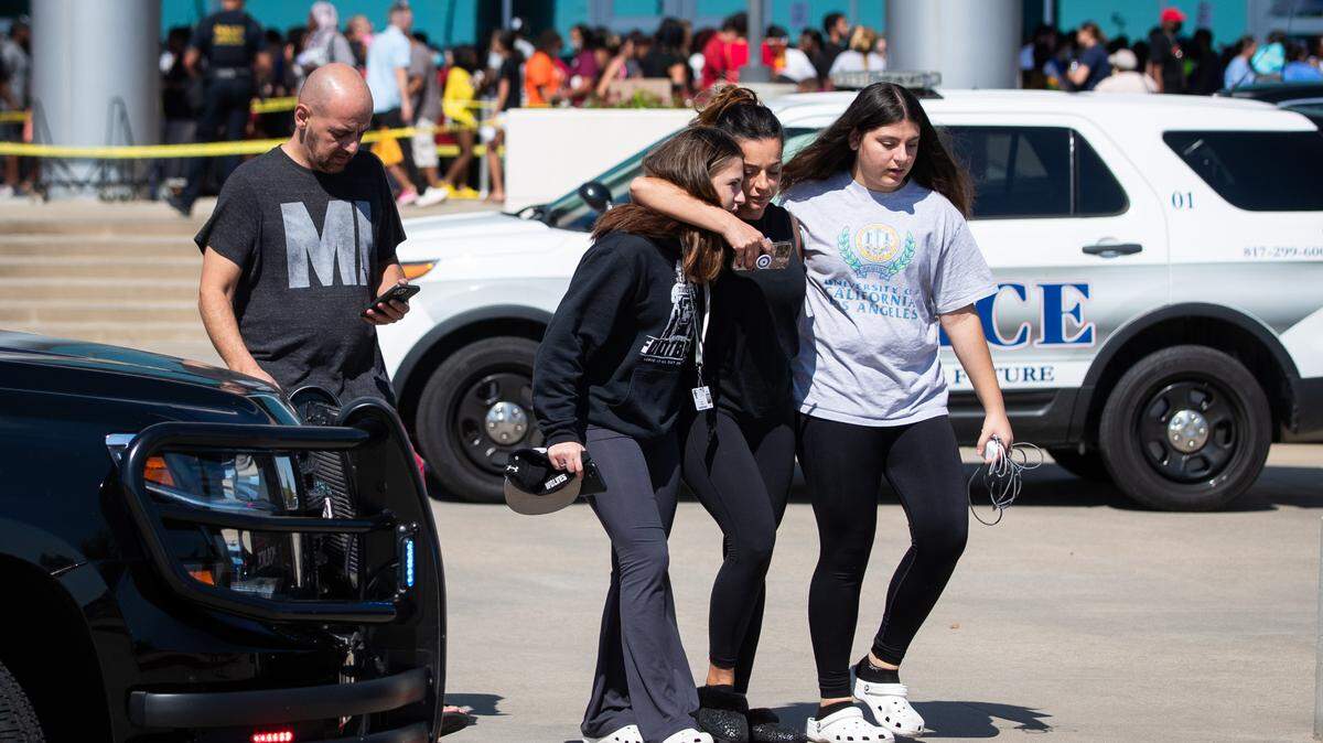Parents pick up their children at Mansfield school district’s Center for Performing Arts after a shooting at Timberview High School Wednesday, Oct. 6, 2021, in Mansfield.