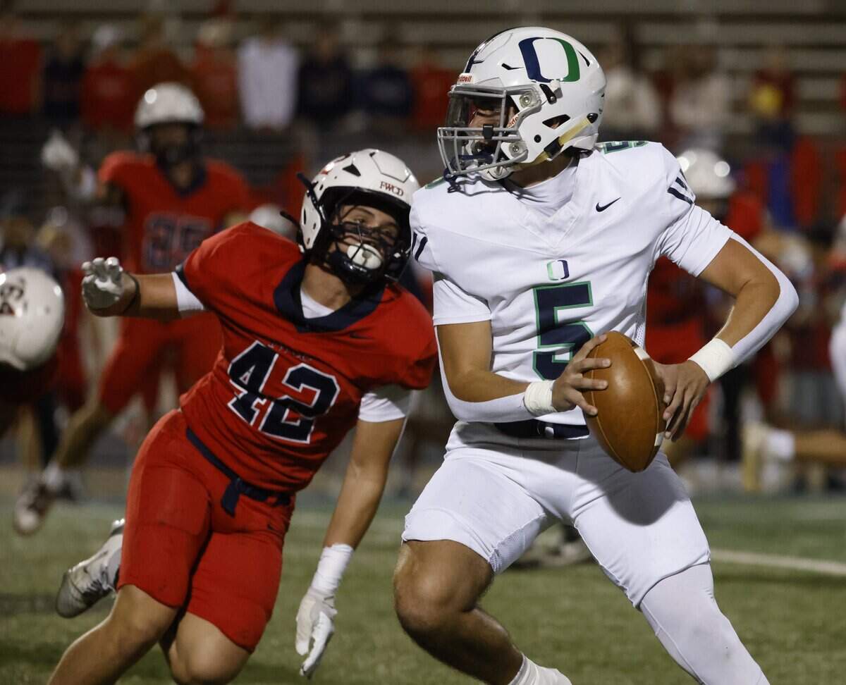 Oakridge quarterback Luke Dearman (5) is pressured in the backfield by Country Day defensive lineman Alex Streett (42) during the first half of the SPC 2025 3A Football Championship football game between The Oakridge School and Fort Worth Country Day at Mavericks Stadium in Arlington, Texas, Saturday Nov. 08, 2025.