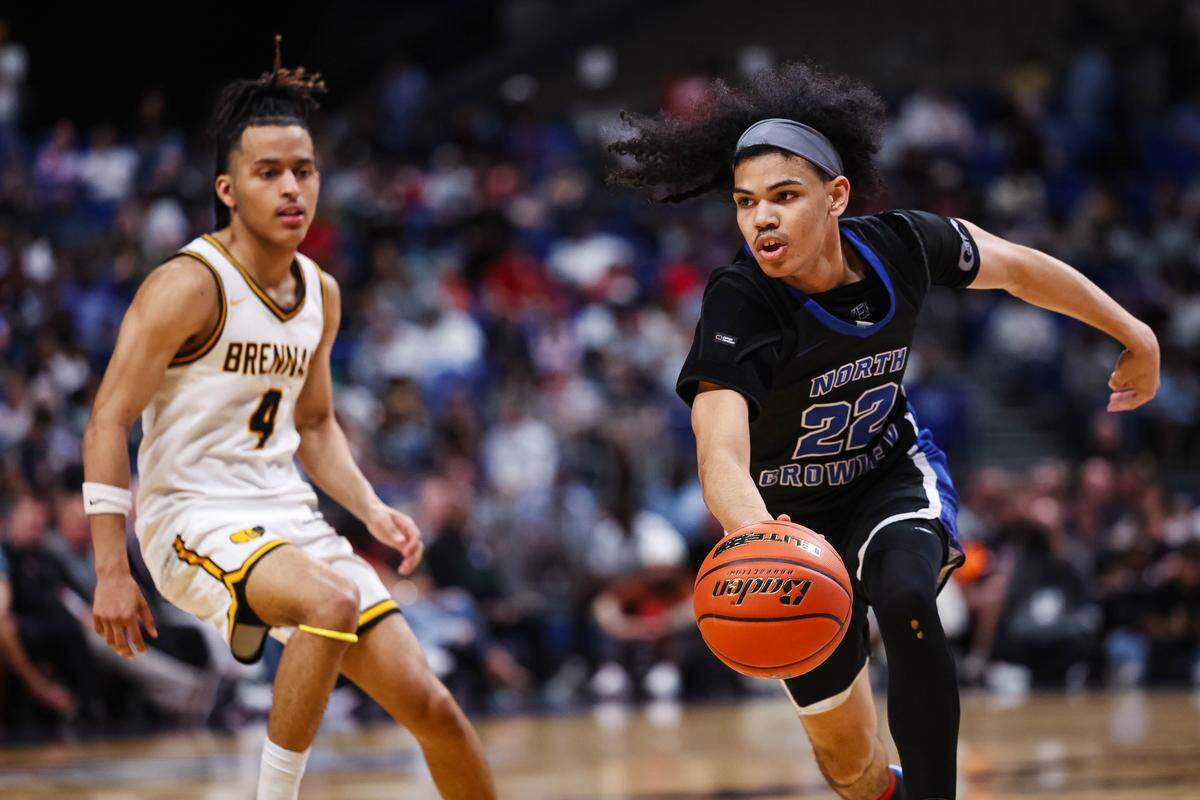 North Crowley guard Isaak Hayes dribbles past a San Antonio Brennan defender in the Class 6A Division I state championship game Saturday at the Alamodome in San Antonio.