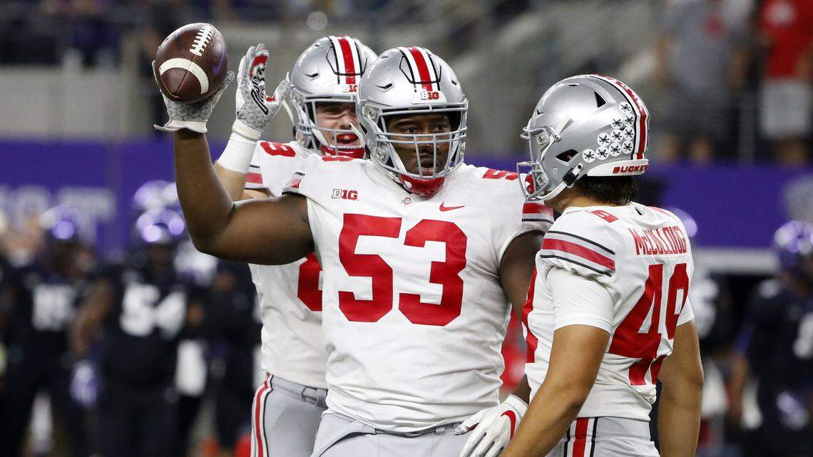 Ohio State defensive tackle Davon Hamilton celebrates his fumble recovery for a touchdown against TCU with Liam McCullough during the first quarter against TCU Saturday night.