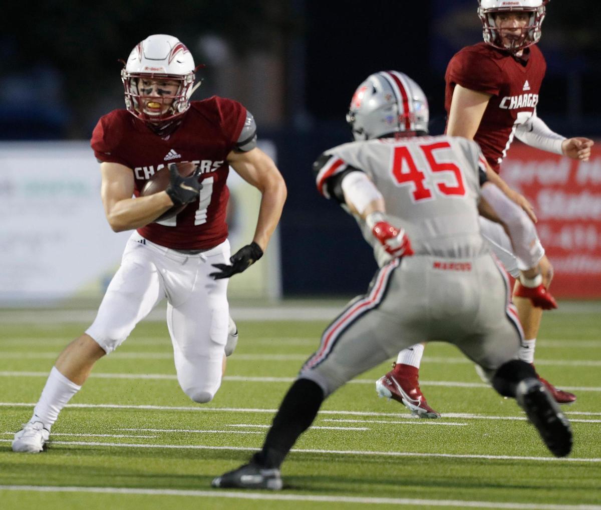 Keller Central running back Preston Hall (21) looks for a way out of the backfield defended by Marcus linebacker Tyler Gainey (45) during a high school football game at Keller ISD Stadium in Keller, Texas, Thursday, Oct. 08, 2020. Keller Central lost their homecoming game to Flower Mound Marcus. (Special to the Star-Telegram Bob Booth)