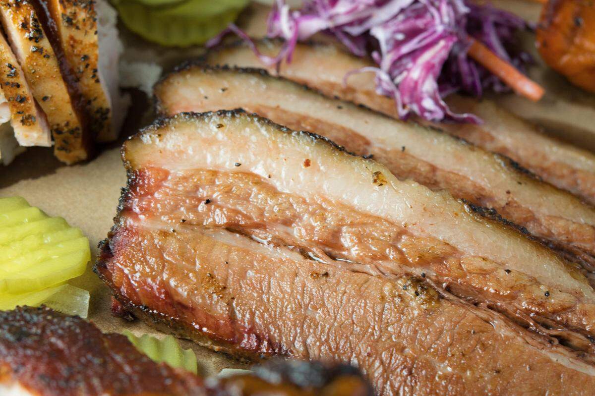 Sliced brisket served with sides of potato salad and coleslaw at Heim Barbecue in Fort Worth. Heim is a local favorite that started as a trailer in 2015 and moved into a full-size location on Magnolia Street.