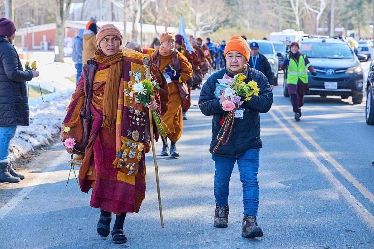 Led by Bhikkhu Pannakara (L), Buddhist monks participate in a "Walk for Peace" in Glen Allen, Virginia, on February 3, 2026. The group is walking from Fort Worth, Texas, to Washington, DC to promote peace, compassion and nonviolence. (Photo by Aaron Mathes / AFP via Getty Images)