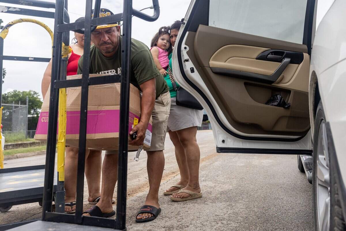 Celso Funez puts a box full of food in his car at the Community Food Bank of Fort Worth on June 15, 2026. Some of the foods that the Community Food Bank provides are meat, dairy and bread.