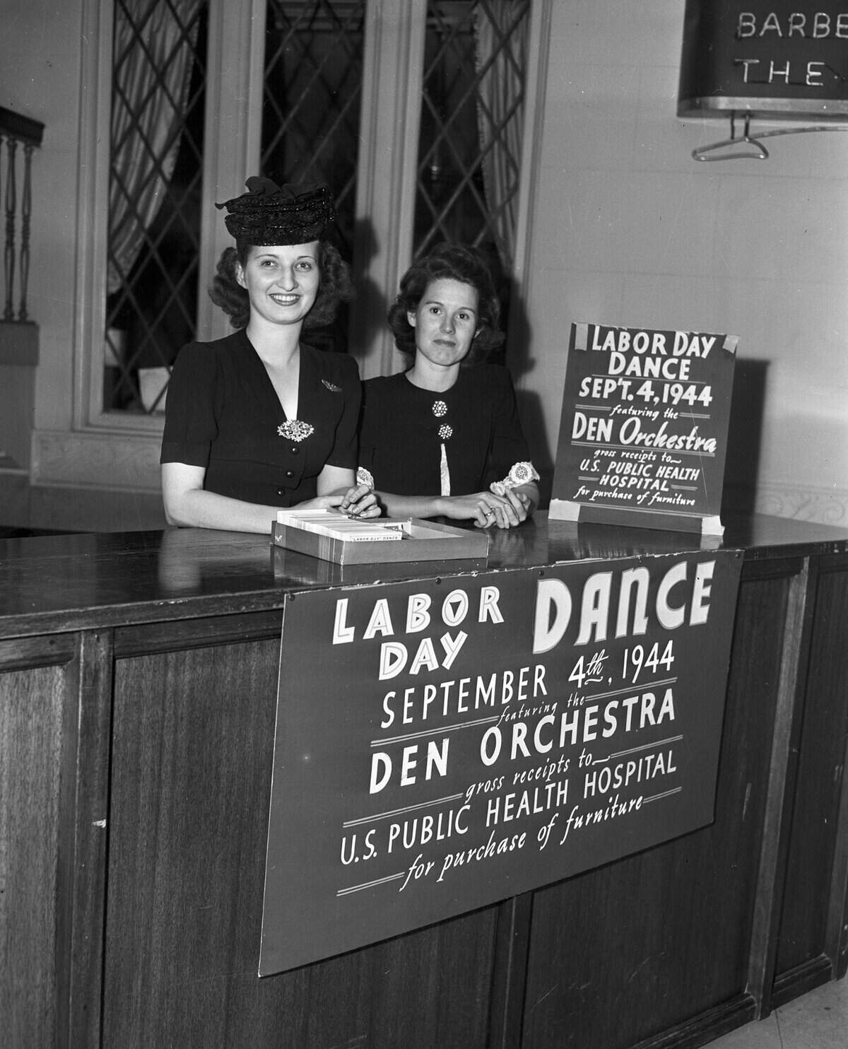 Aug. 28, 1944: Operating the ticket booth in the Hotel Texas lobby for the Labor Day benefit dance to be sponsored by the Wives of Officers Overseas Club are, left to right, Mrs. E.F. Shenlin and Mrs. E.E. Todd. A sign on the front of the booth and a sign on the counter top read “Labor Day Dance September 4th, 1944 featuring the Den Orchestra, gross receipts to U.S. Public Health Hospital for purchase of furniture.”