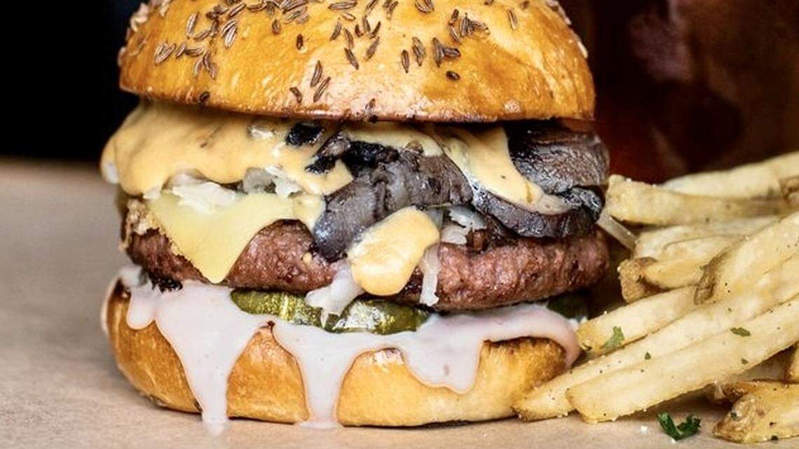 A promotional photo of the Hopdoddy Beyond Meat burger with mushrooms, Gruyere and Russian dressing.
