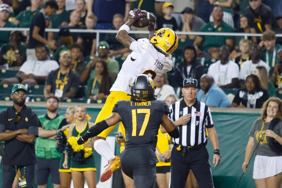Arizona State wide receiver Jordyn Tyson (0) catches a touchdown pass while being defended by Baylor safety Tyler Turner (17) during the second half Saturday at McLane Stadium in Waco, Texas.