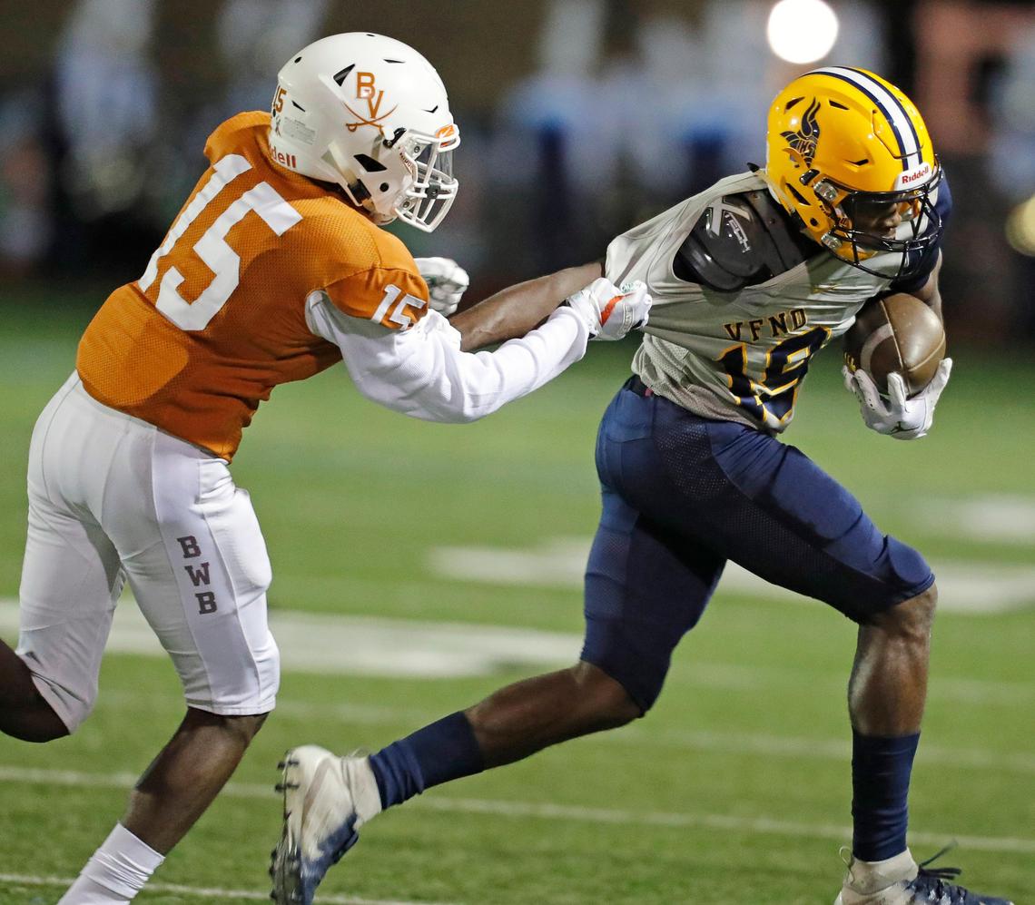 Lamar wide receiver Trevon West (19) drags Bowie defensive back Renaldo Campbell (15) to the sidelines after a catch during the first half of a high school football game at Wilemon Field in Arlington, Texas, Friday, Nov. 01, 2019. The game between Bowie and Lamar was tied at 10 at the half. (Special to the Star-Telegram Bob Booth)