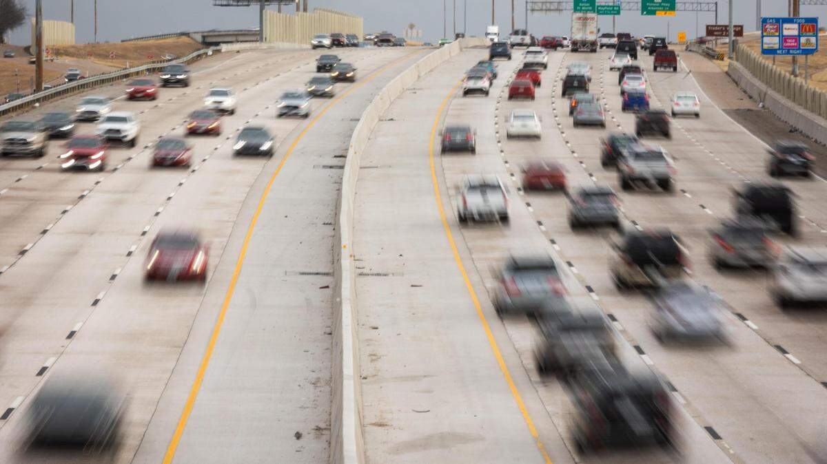 Cars travel on both sides of the highway stretch of Texas 360 between Interstates 30 and 20.