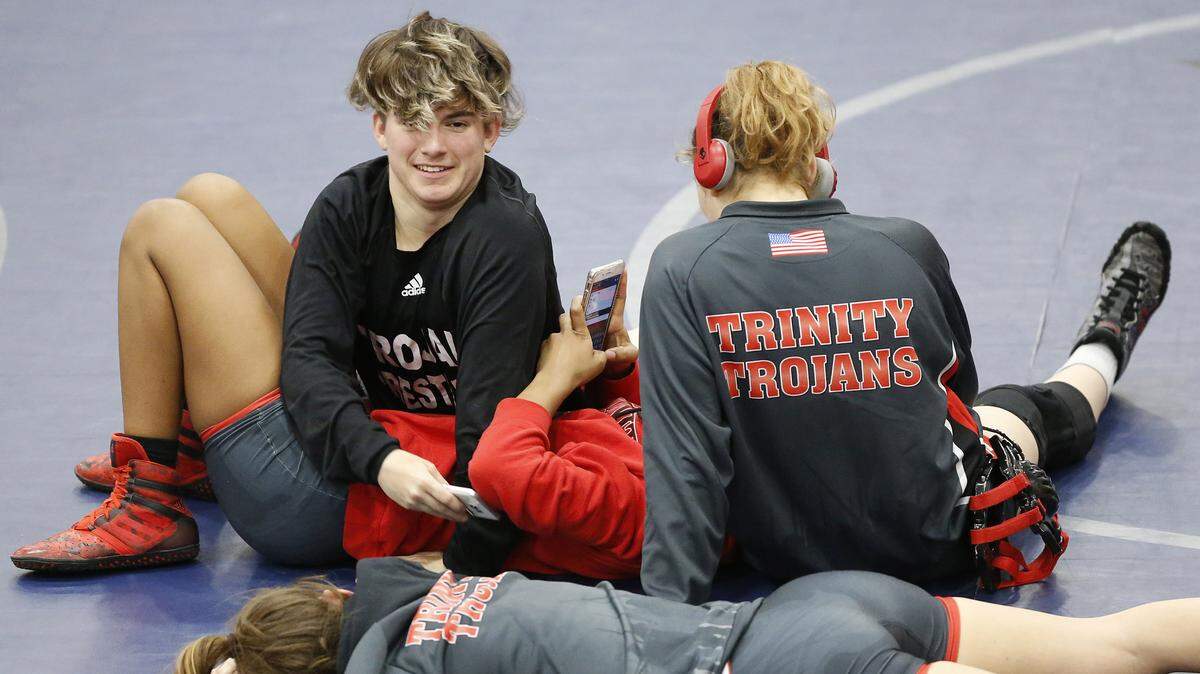 Euless Trinity transgender wrestler Mack Beggs (top, left) hangs out with his female teammates before the 110lb girls final at the District 5-6A wrestling meet in Irving, Texas, Saturday, Feb. 10, 2017.