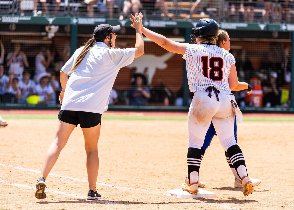Madyson Boutwell and assistant coach Kendall Sifuentes high five during the 5A UIL State Softball semifinal between Aledo and Georgetown in Austin Texas, on June 3rd, 2021.