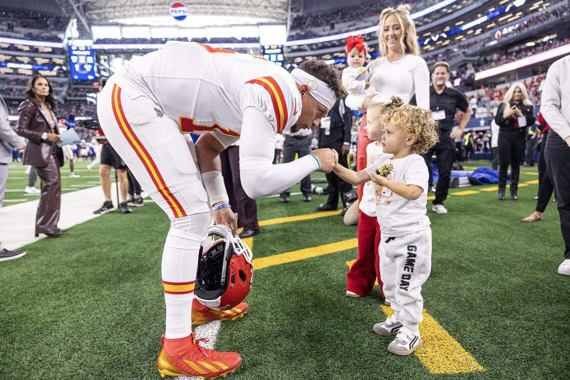 Chiefs quarterback Patrick Mahomes (15) greets his son Patrick "Bronze" Lavon III and his family prior to the first half of an NFL game between the Dallas Cowboys and the Kansas City Chiefs at AT&T Stadium in Arlington on Thursday, Nov. 27, 2025.