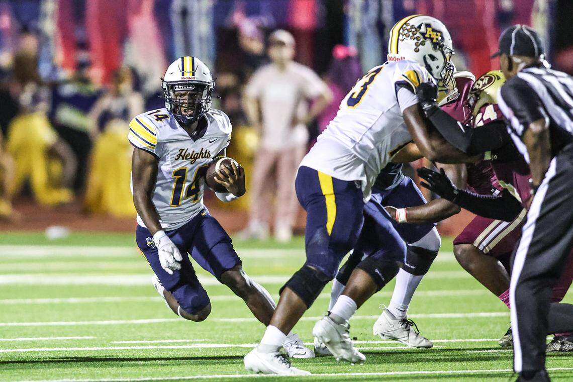 Arlington Heights quarterback Carmelo Carter runs the ball on Thursday, October 10, 2025, at Rough Rider Stadium in Saginaw, Texas.