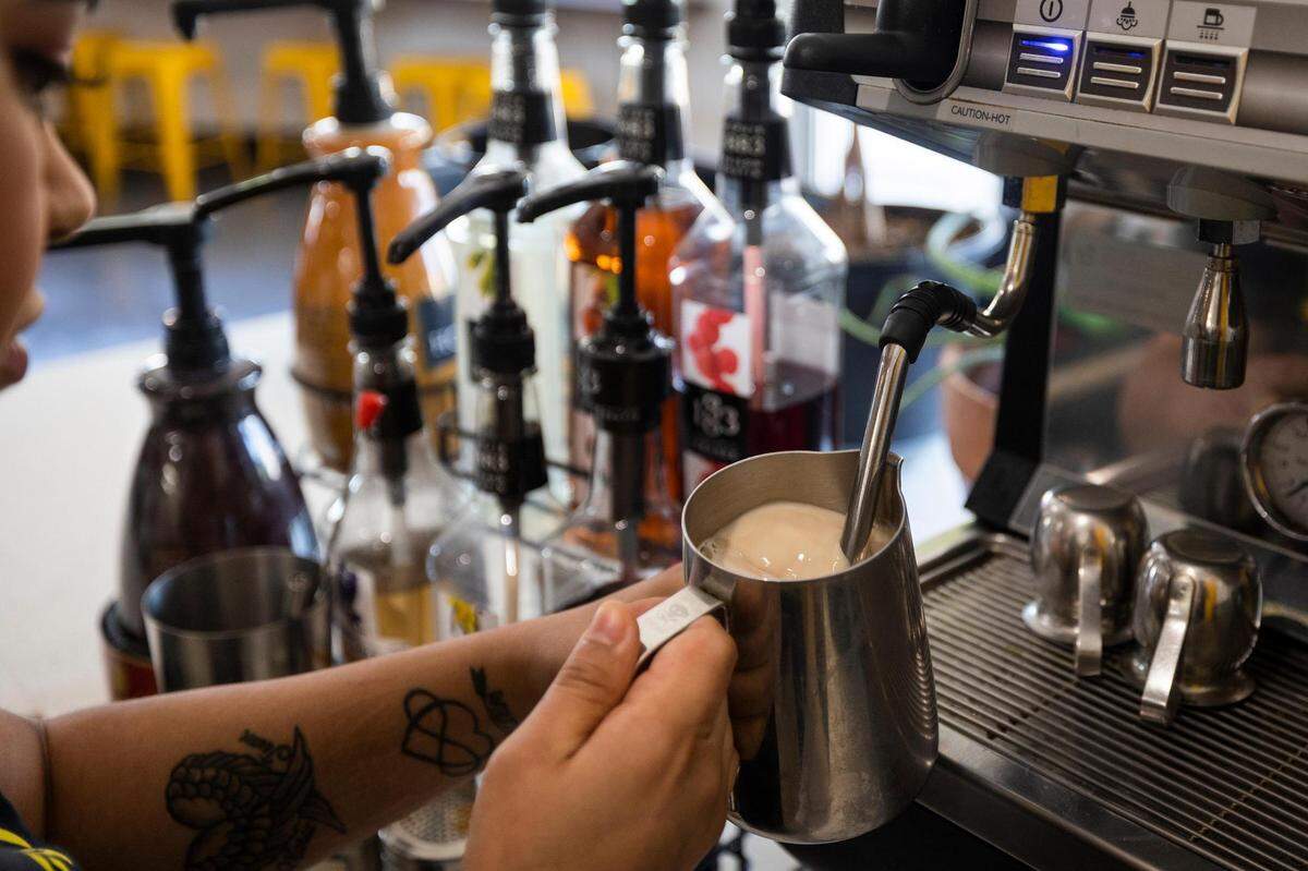 Barista Camille Ornelas steams milk while making a coffee drink Friday, June 24, 2022, at Black Coffee in Fort Worth.