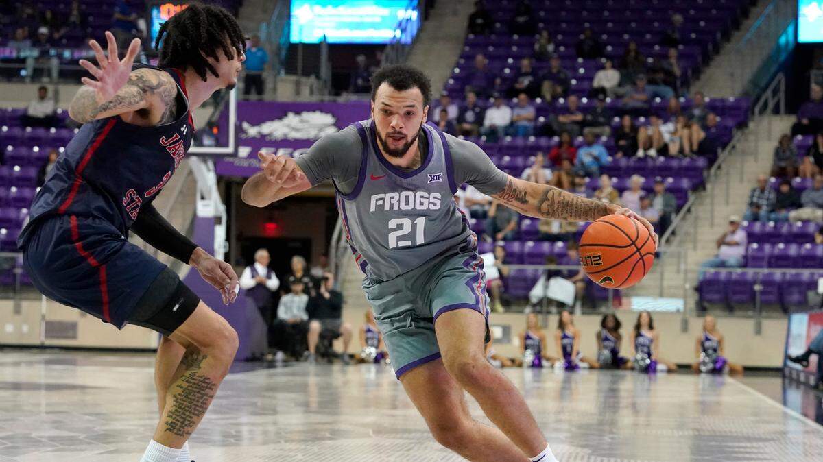 TCU forward JaKobe Coles (21) drives against Jackson State forward Trace Young (3) during the first half of an NCAA college basketball game in Fort Worth, Texas, Tuesday, Dec. 6, 2022. (AP Photo/LM Otero)