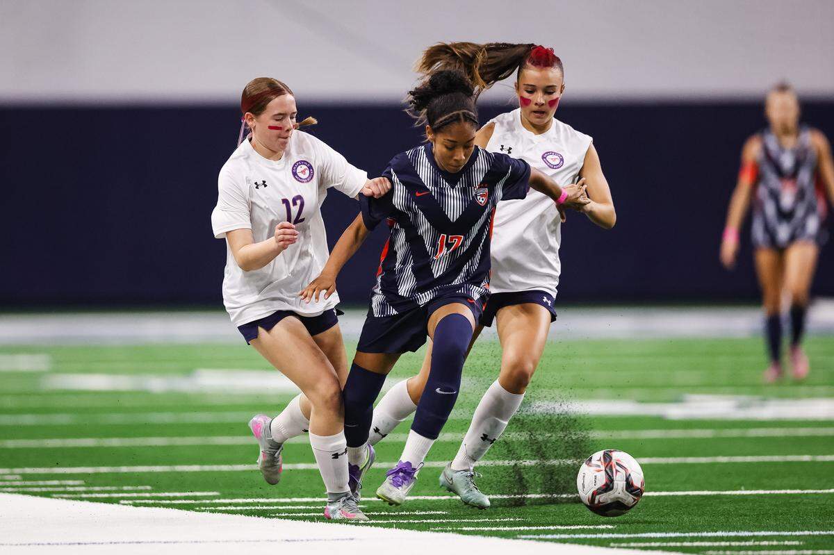 Grapevine forward Eleanor Batikn (12) battles with Frisco Wakeland’s Morgan Landry (17) in a Class 5A Division II UIL girls soccer state semifinal at the Ford Center on April 3, 2026 in Frisco, Texas.